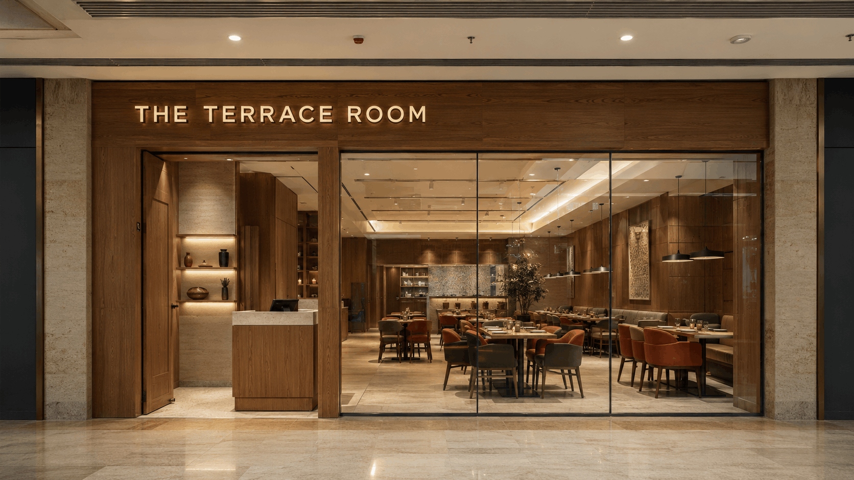 Mall restaurant storefront reading THE TERRACE ROOM with warm wood cladding, backlit signage, and full-height glazing